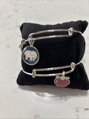 Two Alex & Silver tone Bangle Bracelets.